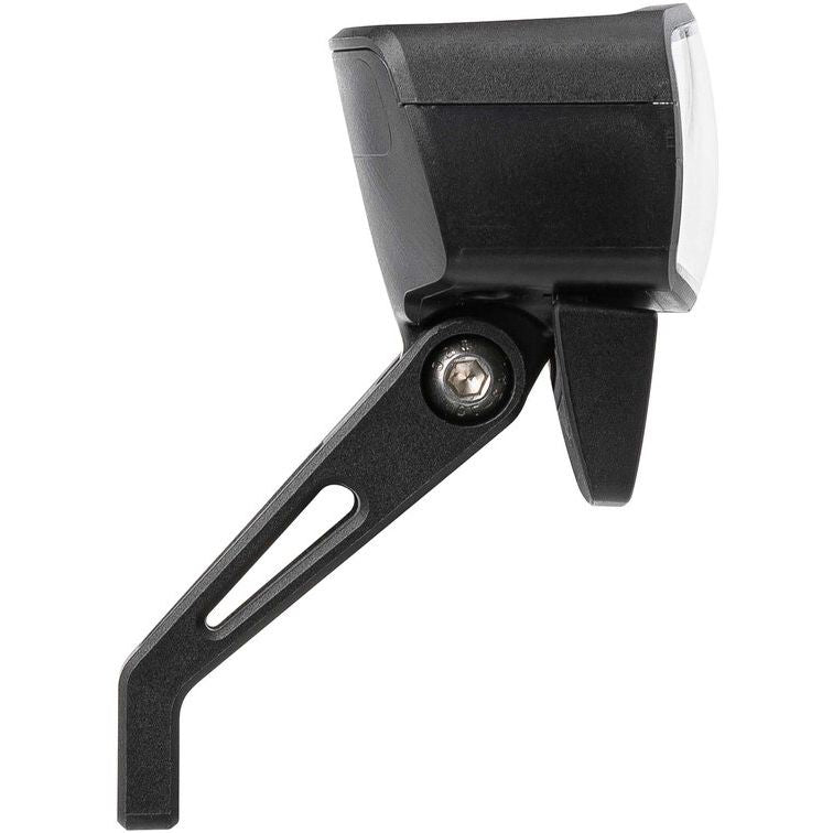 Axa NXT koplamp voor e-bike, 6-12V met geïntegreerde reflector, zwart kunststof, zichtbaar op fiets met wegachtergrond
