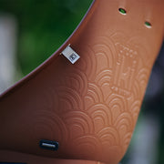 Urban Iki achterfietsstoeltje Ta-ke BIO MIK HD bevestigd op fiets, geschikt voor kinderen, zwart met comfortabele zitting.