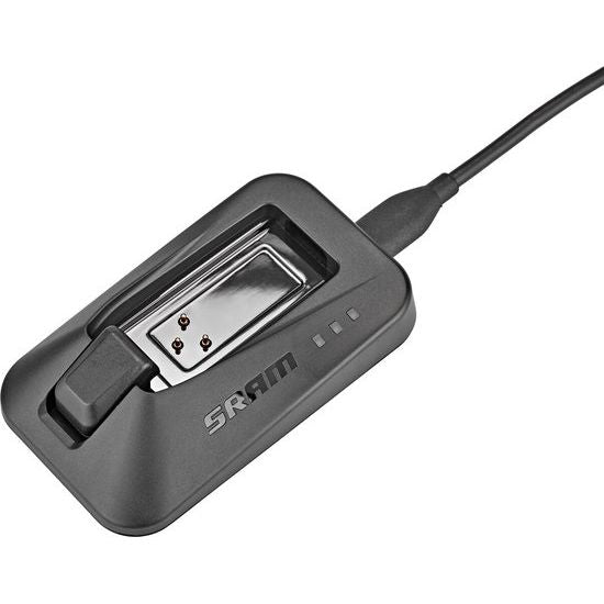 Sram Axs acculader voor e-bike accu's, zwart, met oplaadkabel op een witte achtergrond
