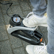Aluminium SKS Airstep voetpomp met manometer en voetbediening voor fietsen en banden, stevig en gebruiksvriendelijk.