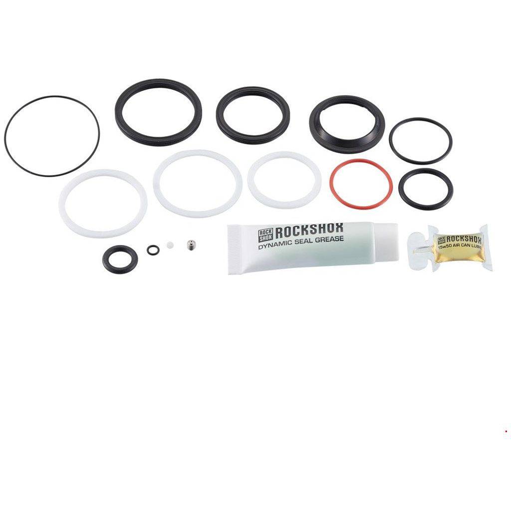RockShox Deluxe Servicekit voor schokdempers, inclusief onderdelen voor onderhoud en reparatie, op een werkbank weergegeven.