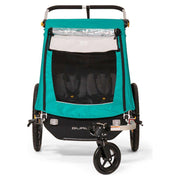 Burley Encore X kinderfietskar voor 2 kinderen, inklapbaar met vering en veiligheidsriemen op een fiets.