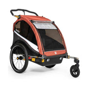 Burley Cub X kinderfietskar met verstelbare vering in Sandstone Red en Charcoal Grey, geschikt voor twee kinderen.