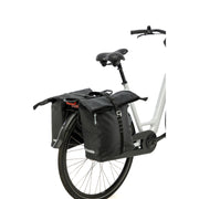 Zwarte New Looxs Cantos dubbele fietstas met 36 liter inhoud, bevestigd aan een fiets voor dagelijks gebruik.