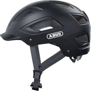 Abus Hyban 2.0 e-bike fietshelm met geïntegreerd LED-achterlicht en ventilerende naden, in zwart met reflecterende details.