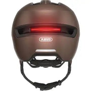 Abus Hud-Y Urban E-bike helm met magnetische USB-LED verlichting en ventilerende design, zwart met reflecterende details.