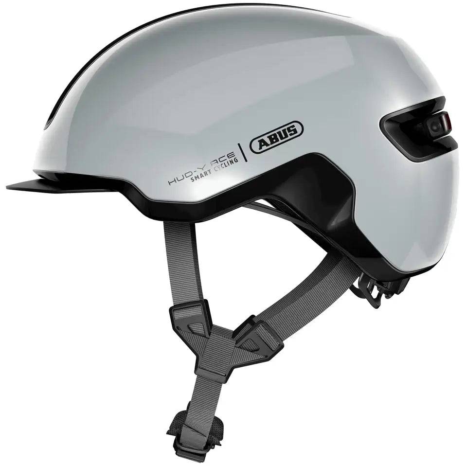 Abus Hud-Y E-bike helm met magnetisch USB-achterlicht en reflecterende details, geschikt voor stadsfietsen en urban gebruik.