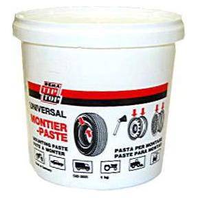 Bandenmontagepasta Tip Top van 1 kg, geschikt voor bandreparatie, in een open container met label en gereedschap op de achtergrond.