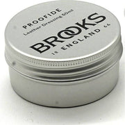 Brooks Zadelvet Proofide smeermiddel voor zadels, zichtbaar in een open pot met smeermiddel en een applicator.