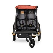 Burley Cub X kinderfietskar met verstelbare vering in Sandstone Red en Charcoal Grey, geschikt voor twee kinderen.