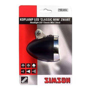 Zwarte Simson Classic Mini voorvork koplamp met ronde behuizing, zichtbaar op een motorfiets.